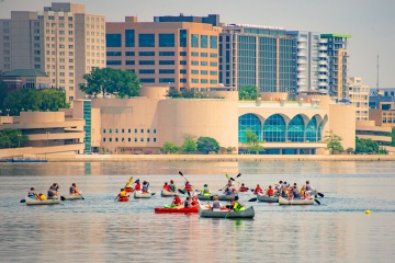 Scenic view of kayakers on Lake Monona with the Madison skyline in the background 